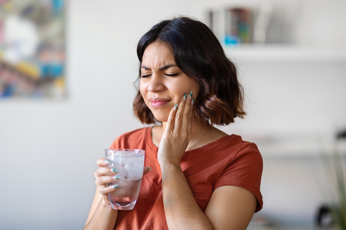 Person experiencing pain from broken tooth