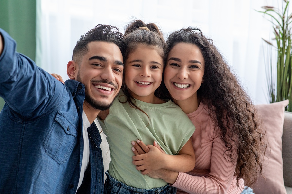 Happy family smiling together with healthy teeth